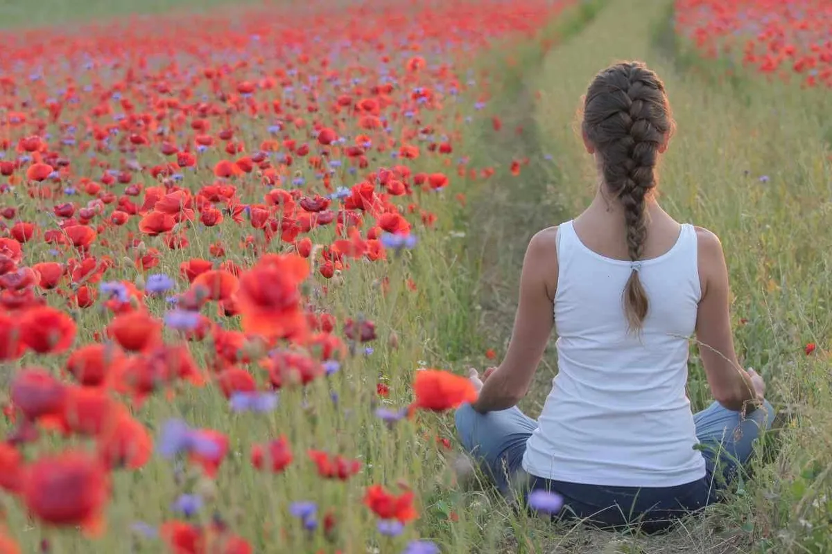 Person sitting calmly with eyes closed during a quiet breathing practice
