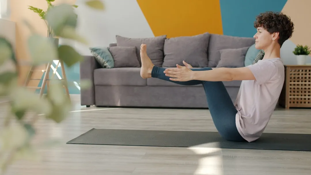 Person balancing on the sitting bones with the legs lifted in boat pose